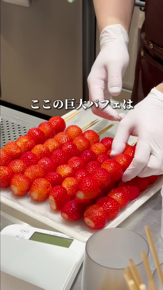 いちごを串に刺して積み上げる様子